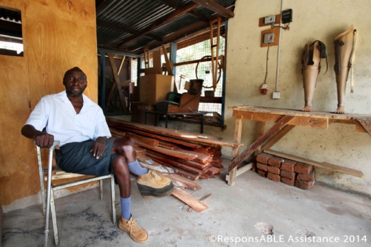 A KDPO staff member sitting in the workshop which is where equipment is made and repaired for local disabled people