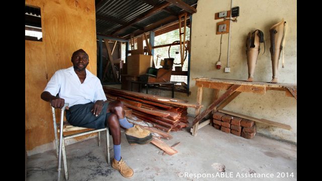 A KDPO staff member sitting in the workshop which is where equipment is made and repaired for local disabled people