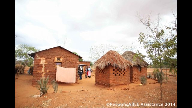 Four small buildings surround a communal yard