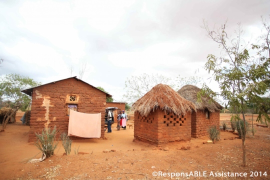 Four small buildings surround a communal yard