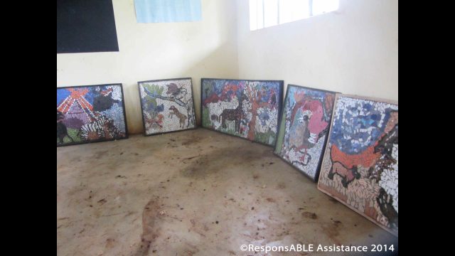 A collection of beautiful mosaic pictures are displayed on the ground in one classroom