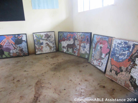 A collection of beautiful mosaic pictures are displayed on the ground in one classroom