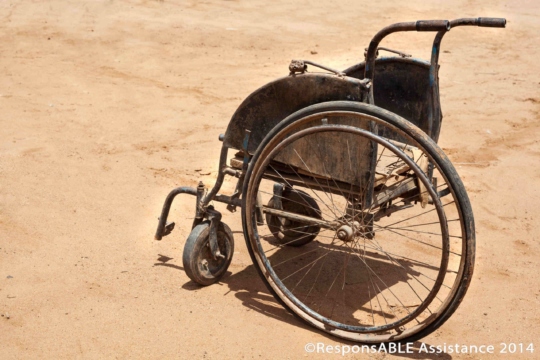Another wheelchair brought out for us to see is very old and damaged and with only one large back wheel left