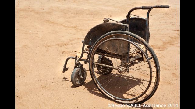 Another wheelchair brought out for us to see is very old and damaged and with only one large back wheel left